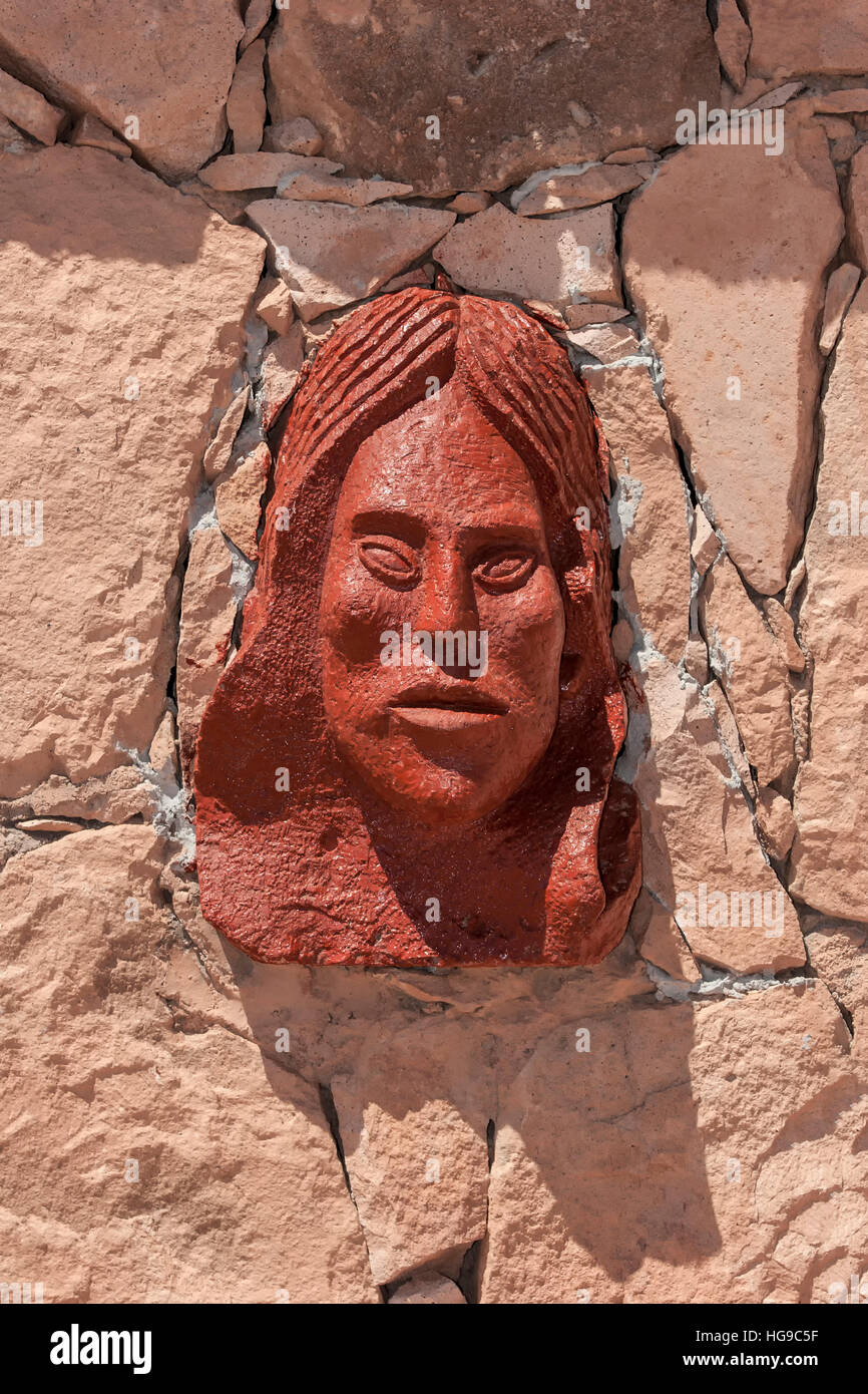 Sculpture of Indian woman's face, memorial to local Indians massacred by the Spanish in 1540, near San Pedro de Atacama, Chile Stock Photo