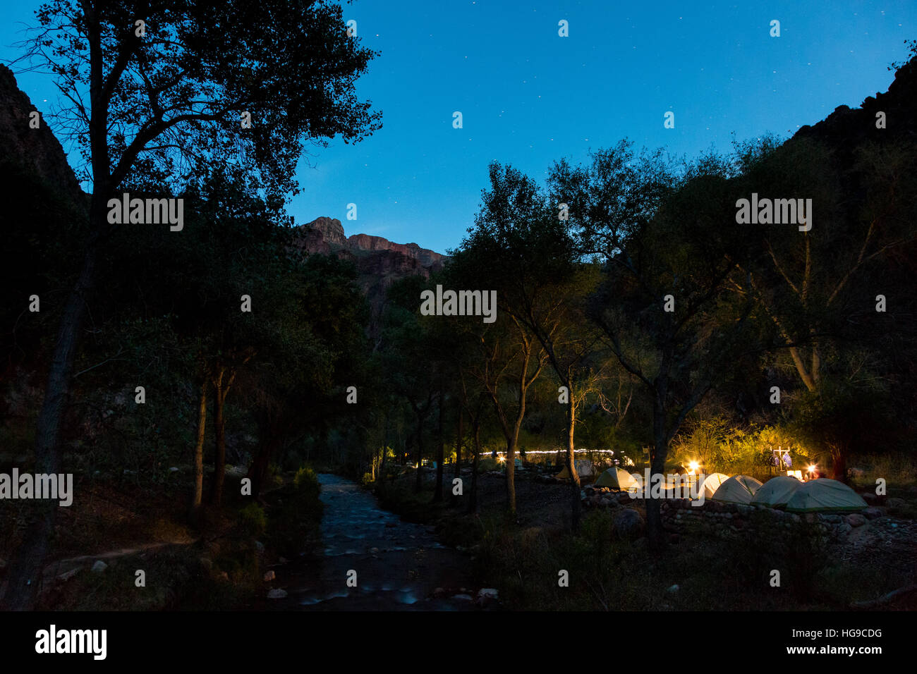 Campers at the Bright Angel Campground at Phantom Ranch in the Grand Canyon at twilight. Grand Canyon National Park, Arizona Stock Photo