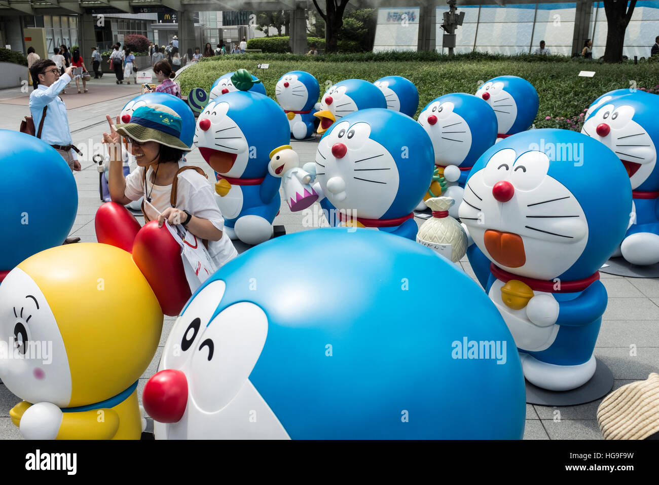 People look at Doraemon character statues at Roppongi Hills in Tokyo, Japan. Stock Photo
