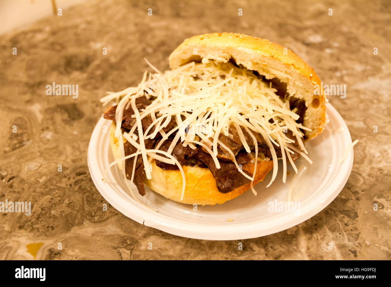 Pani ca meusa is a Sicilian street food. Literally, its name means "bread with spleen"; its Italian name is panino con la milza. Stock Photo
