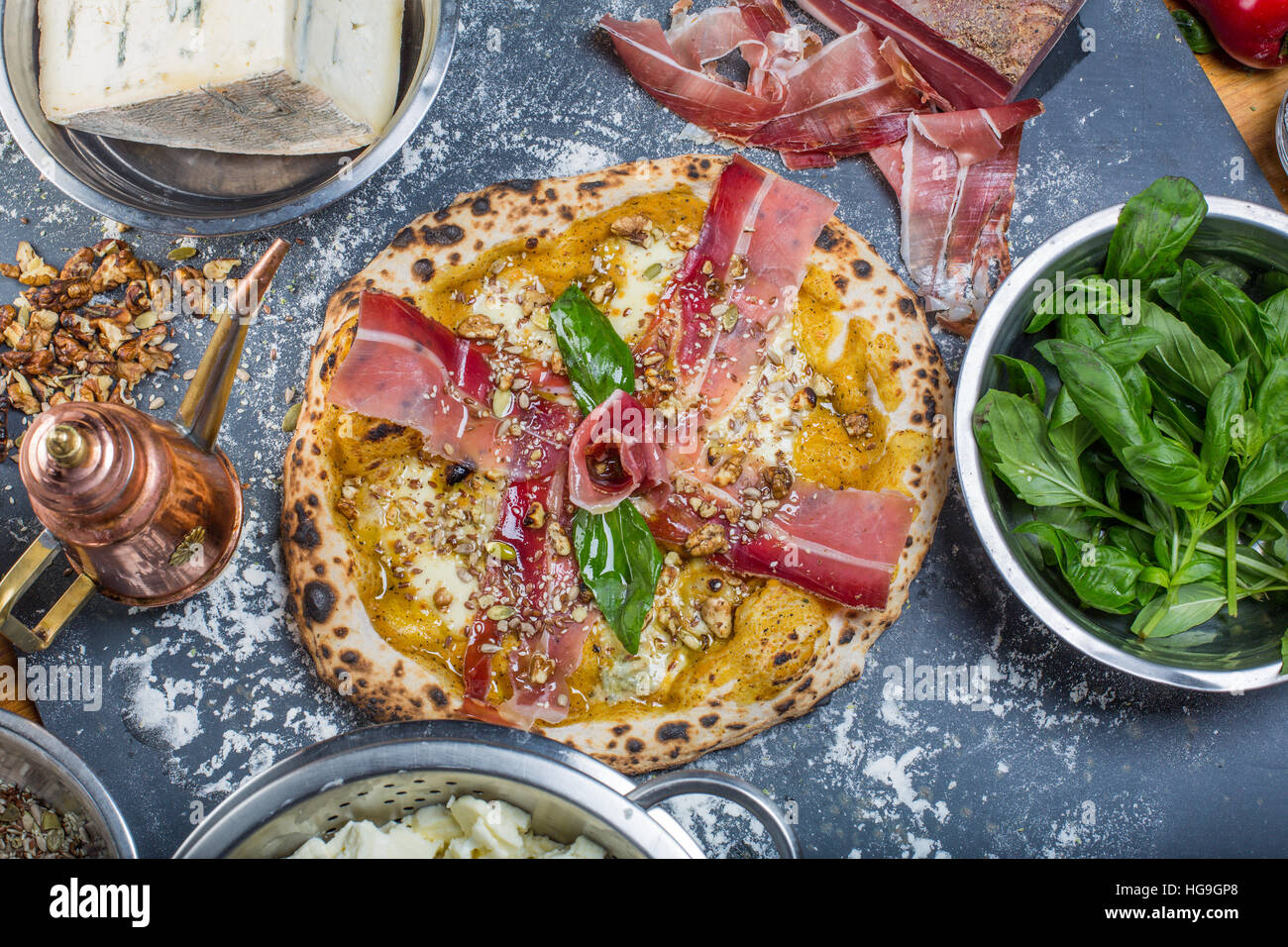 Traditional italian pizza with pumpkin pesto, ham, and seeds