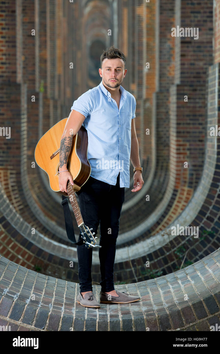 Full Shot of Man holding an Acoustic Guitar · Free Stock Photo