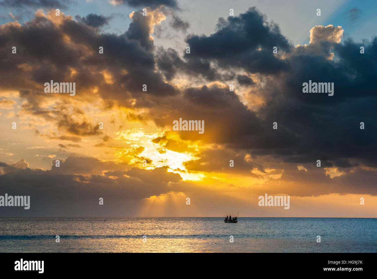 Fishing boat drifting on Savu Sea around sunset time off the coast of Rote Island, seen from Batu Termanu in Rote Ndao, East Nusa Tenggara, Indonesia. Stock Photo