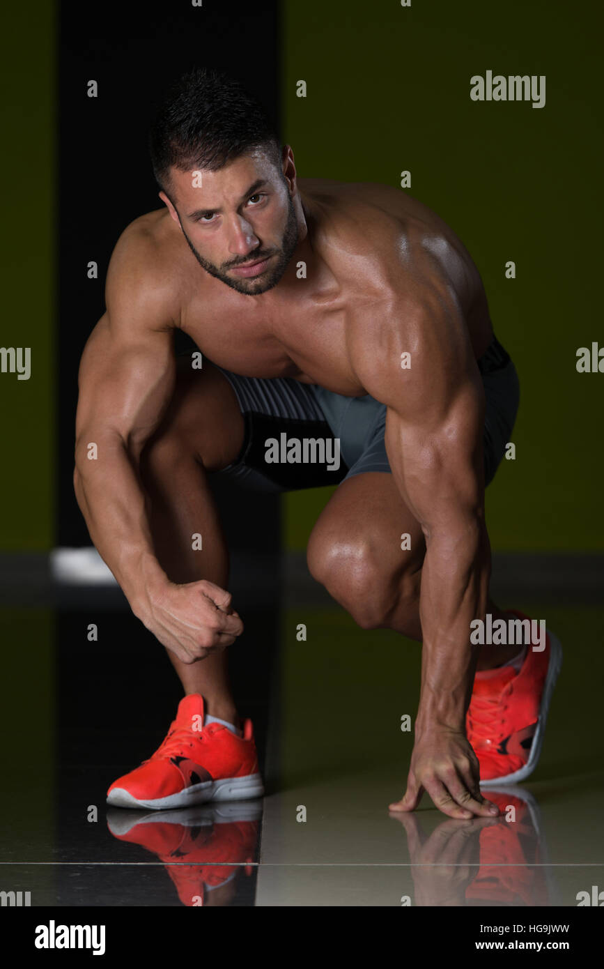 Strong muscular men kneeling on hi-res stock photography and images - Alamy