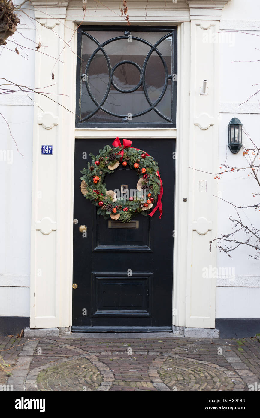 Front door from historic house in Amersfoort decorated with a Christmas wreath Stock Photo