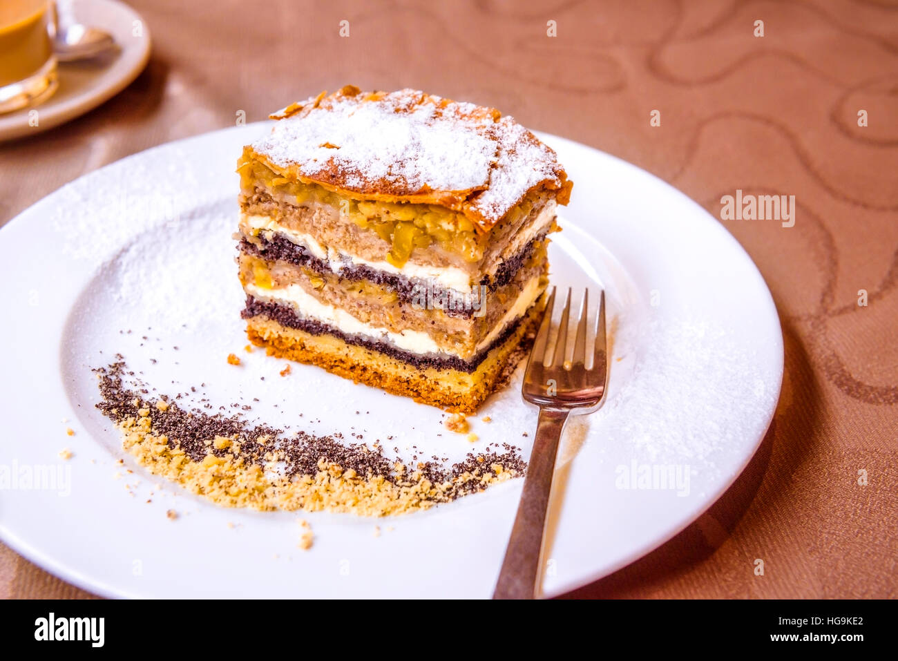 Exquisite sweet dessert, a traditional cake from Prekmurje with poppy seeds, nuts, cottage cheese and apple layers, called Prekmurska gibanica. Stock Photo