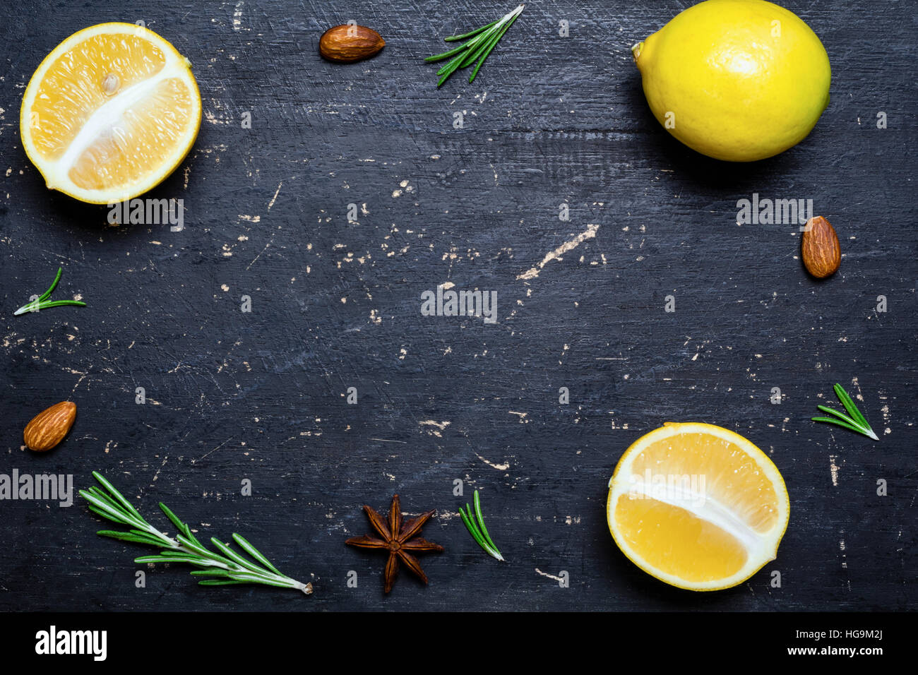 Fresh lemons frame on dark black wooden background. Healthy food cooking background. Copy space for text Stock Photo