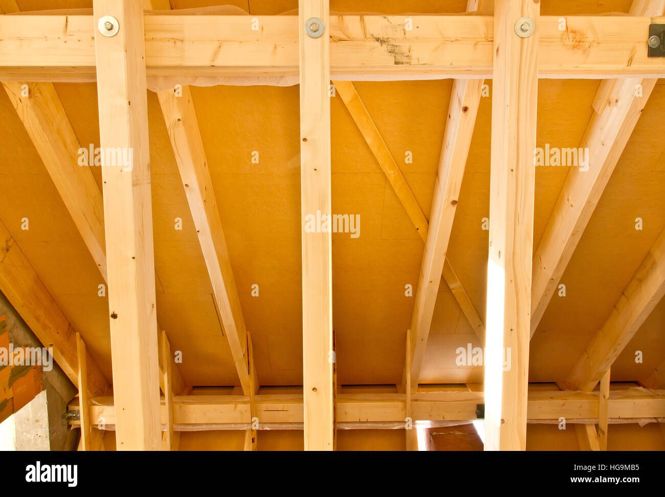 Indoor image of a wooden frame roof truss construction on a new house Stock Photo