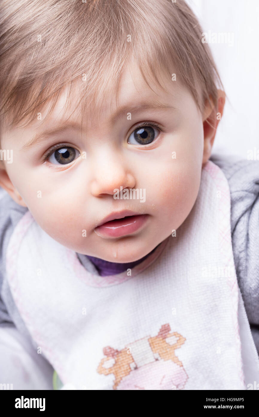 close up portrait of a little infant girl with her bib Stock Photo - Alamy