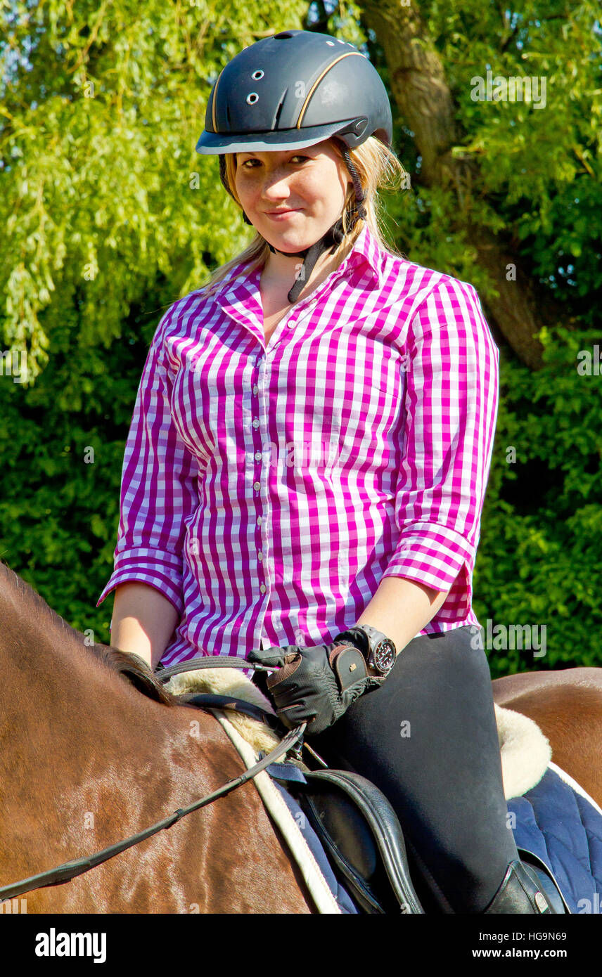 Horseback riding girl on meadow Stock Photo
