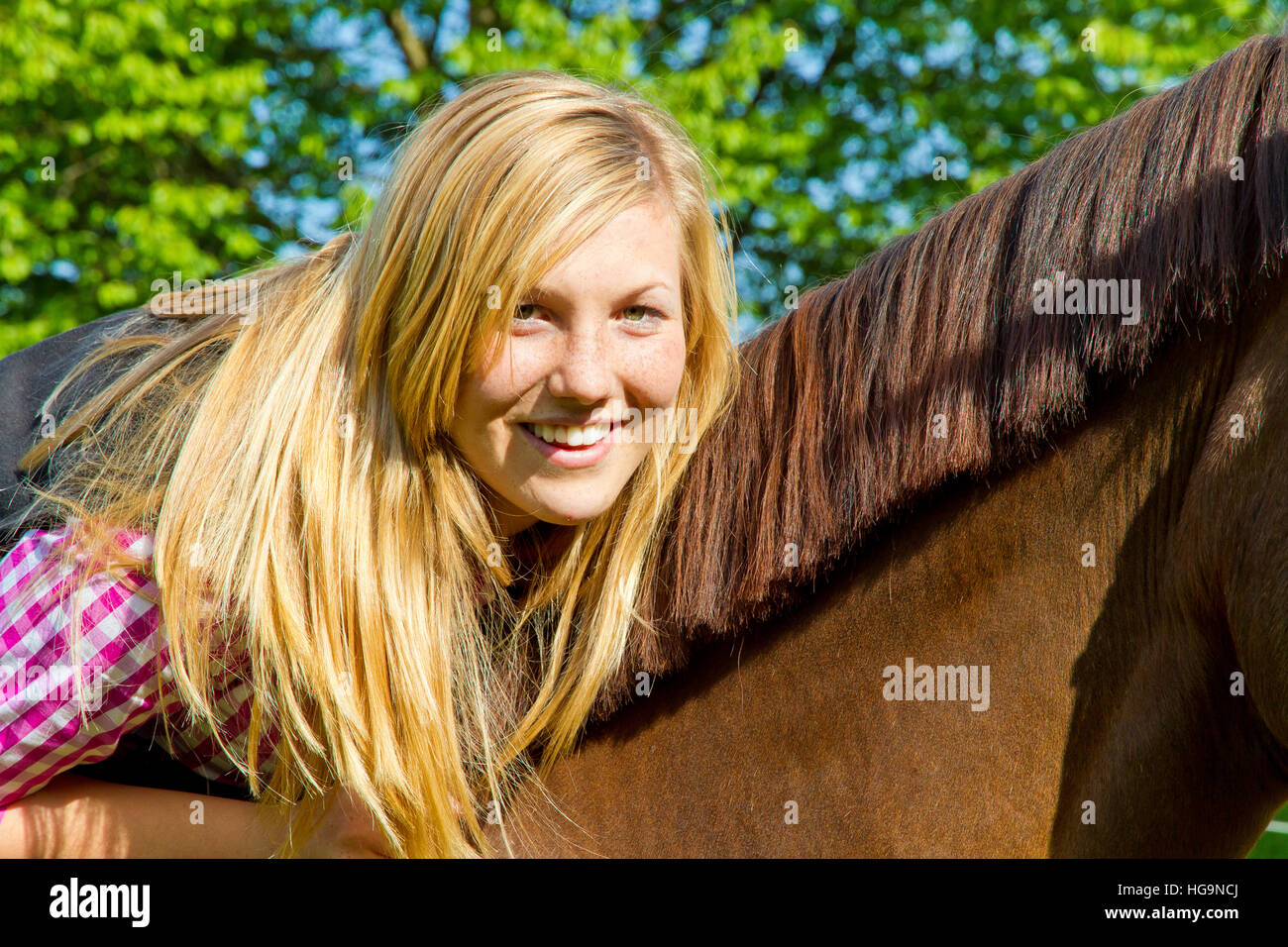 Portrait of a happy girl riding on a horse Stock Photo