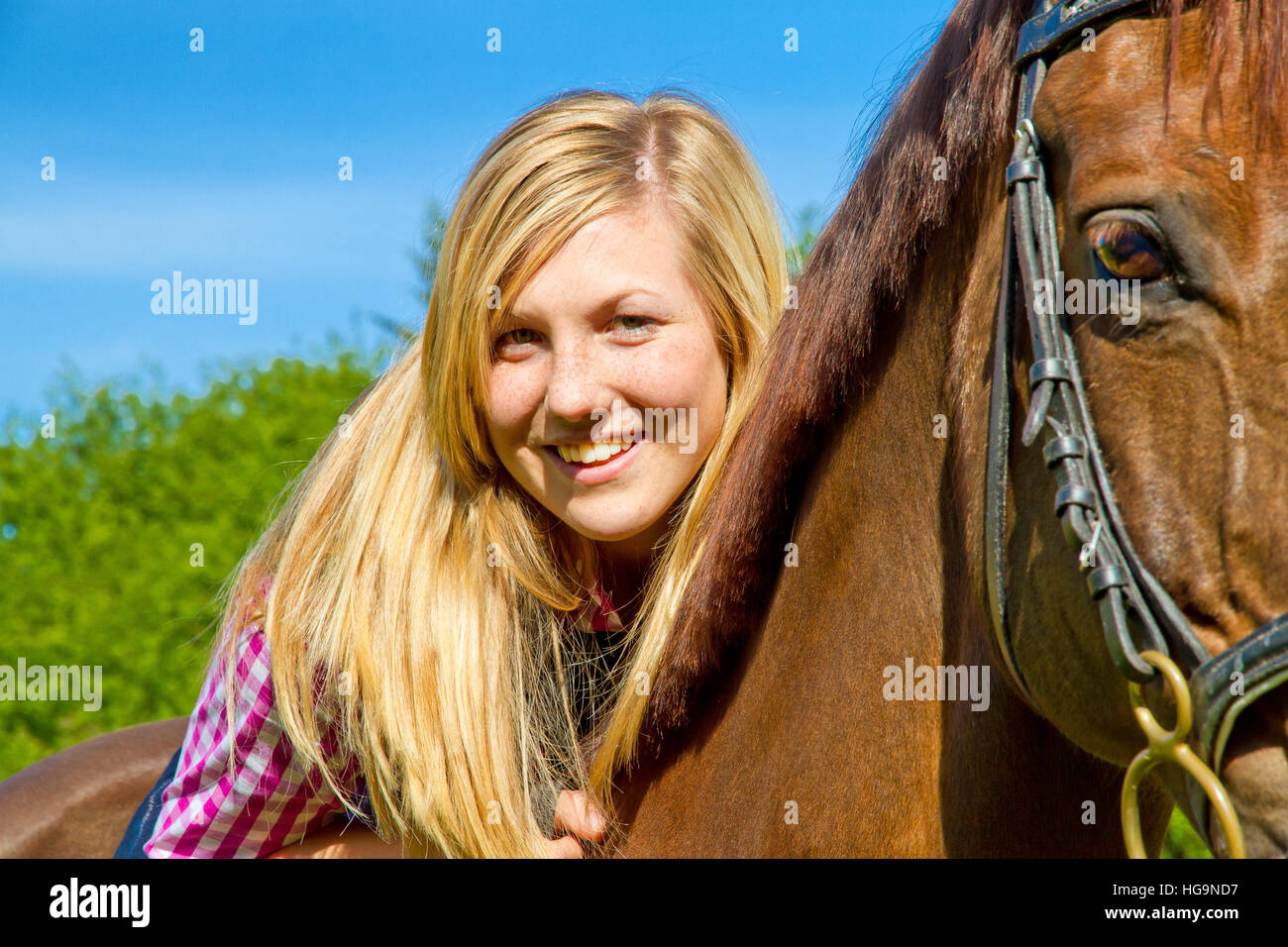 Portrait of a happy girl riding on a horse Stock Photo