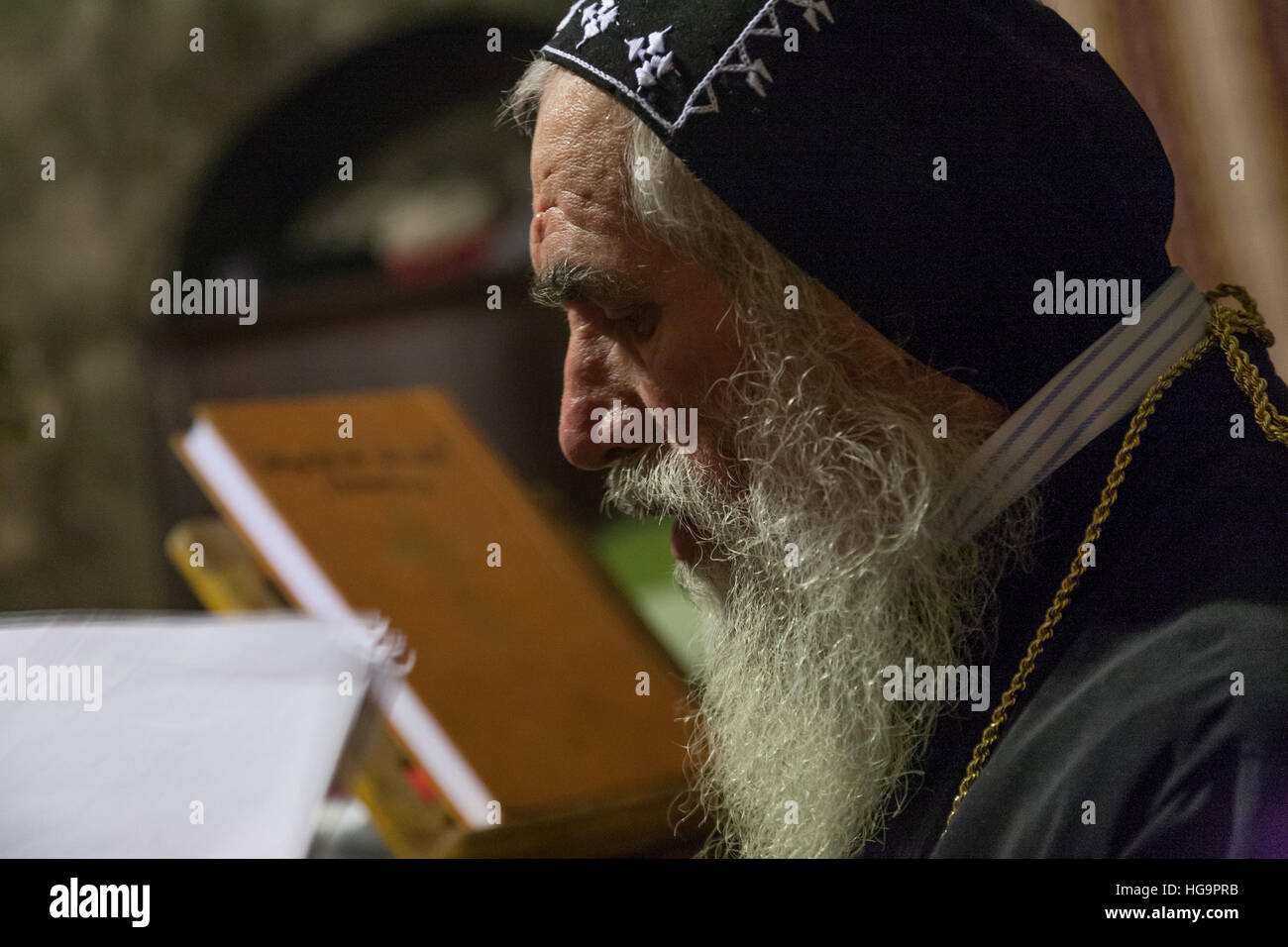 Jerusalem, Israel - December 26, 2010: Syrian Orthodox priest  holds Sunday mass in the Syrian Chapel next to Saint Joseph of Eritrea tomb in the Chur Stock Photo