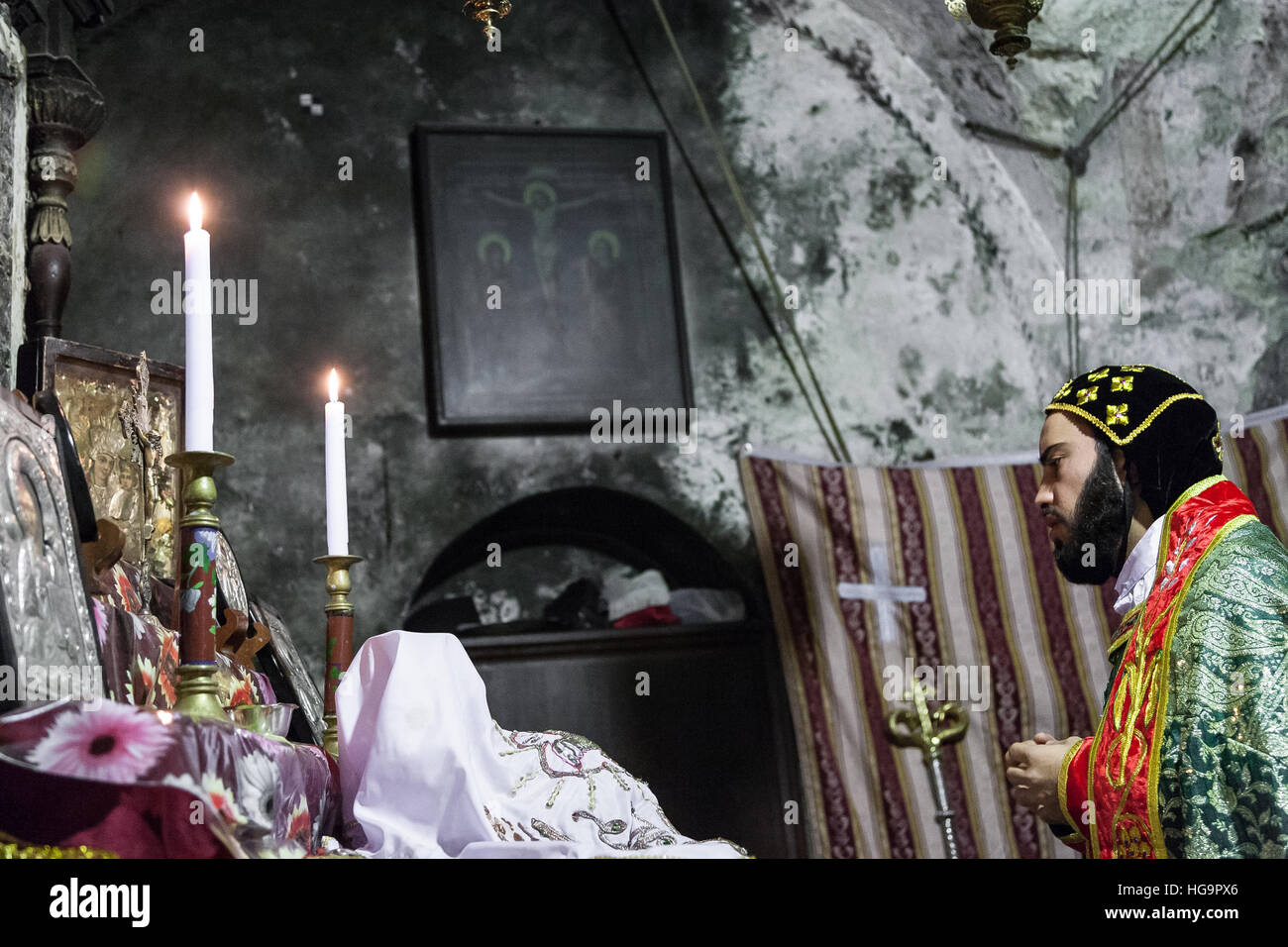 Jerusalem, Israel - January 2, 2011: Syrian Orthodox priest  holds Sunday mass in the Syrian Chapel next to Saint Joseph of Eritrea tomb in the Church Stock Photo