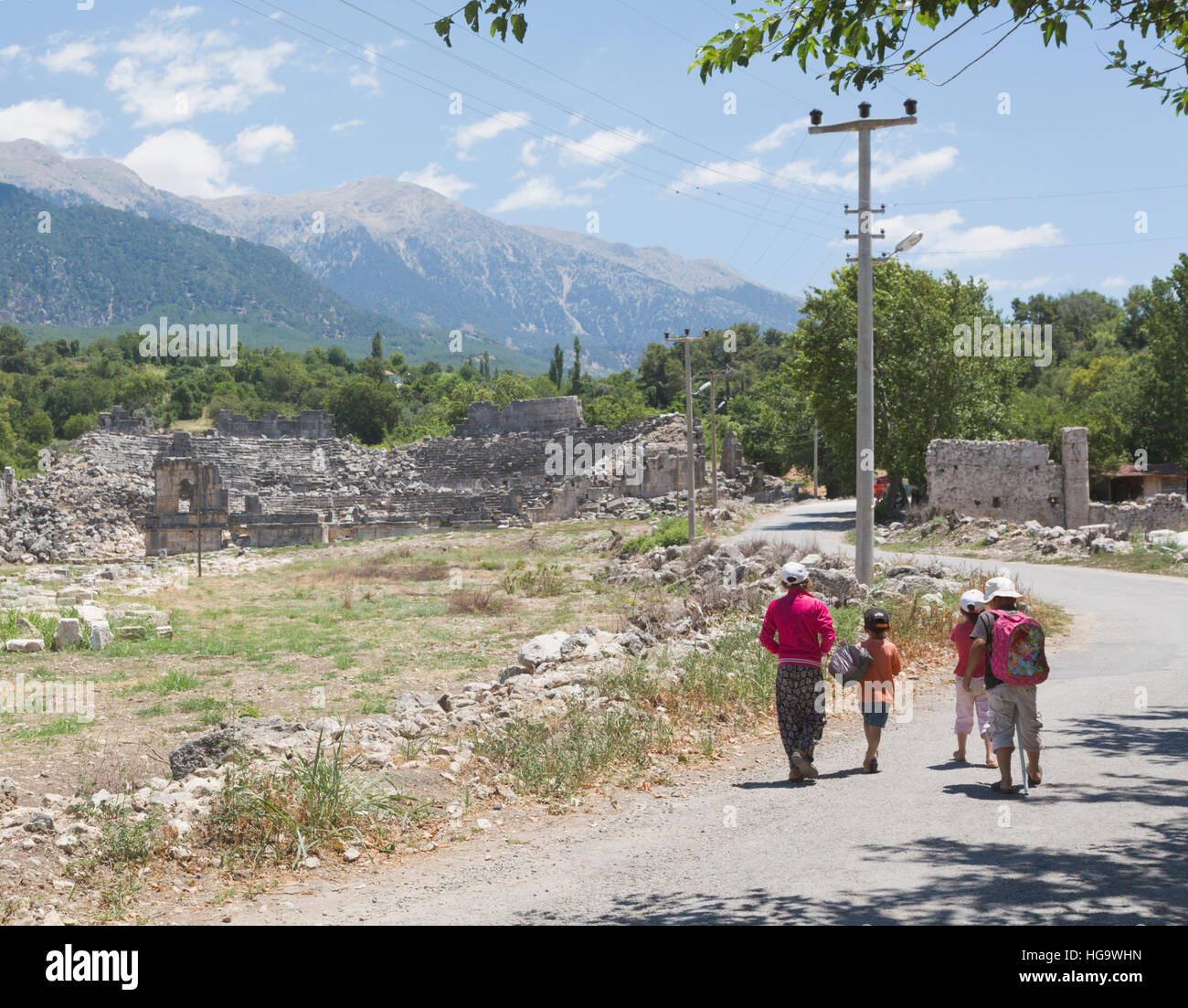 Tlos, Antalya Province, Turkey.  Ruins of the ancient city.  Children on road in front of theatre dating from Roman era. Stock Photo