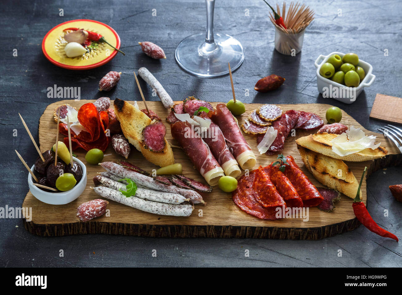 Mix of different snacks and appetizers. Spanish tapas on a black stone