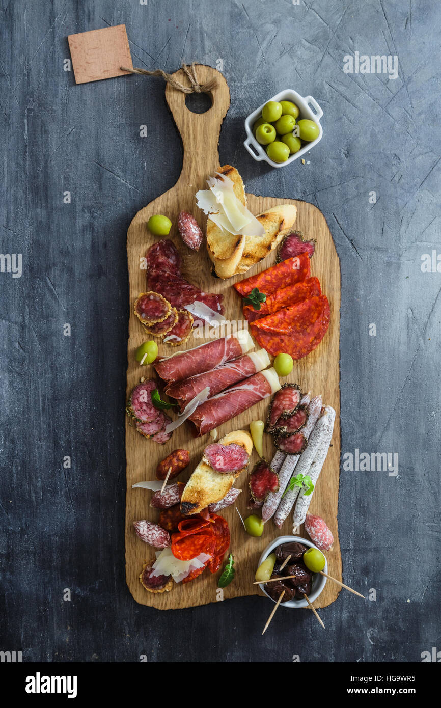 Different spanish embutidos on a table: jamon, chorizo, salami, cheese and wine. Top view Stock Photo