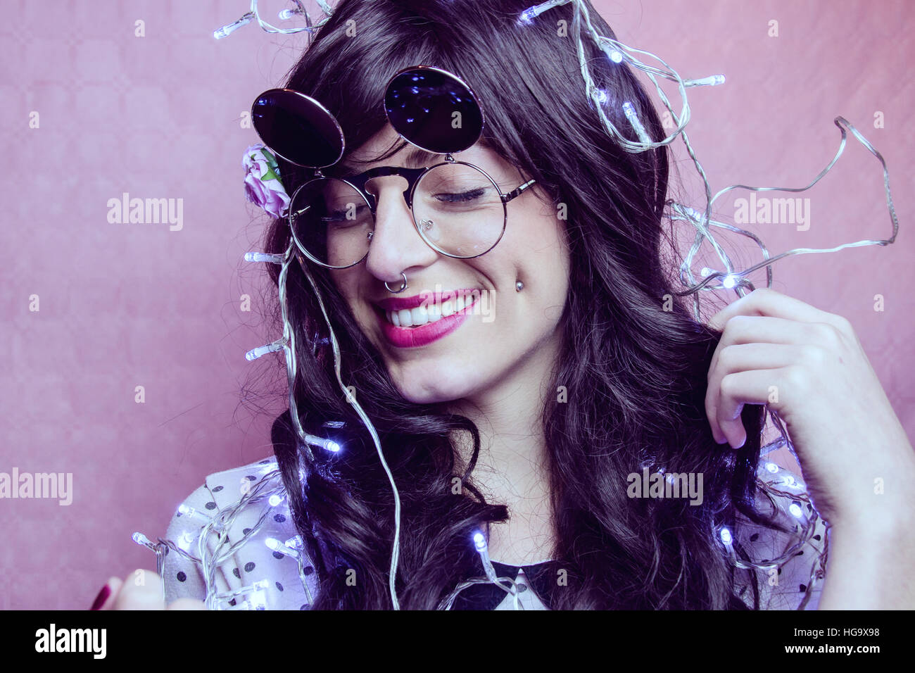 Young woman enjoying a party wearing christmas lights Stock Photo Alamy