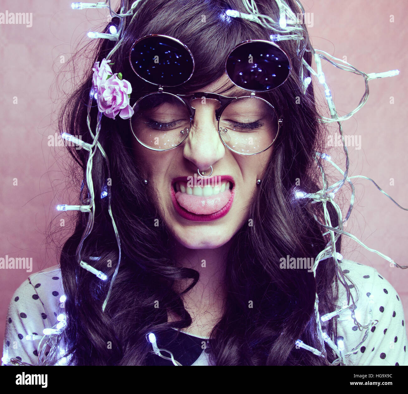 Young woman enjoying a party wearing christmas lights Stock Photo Alamy