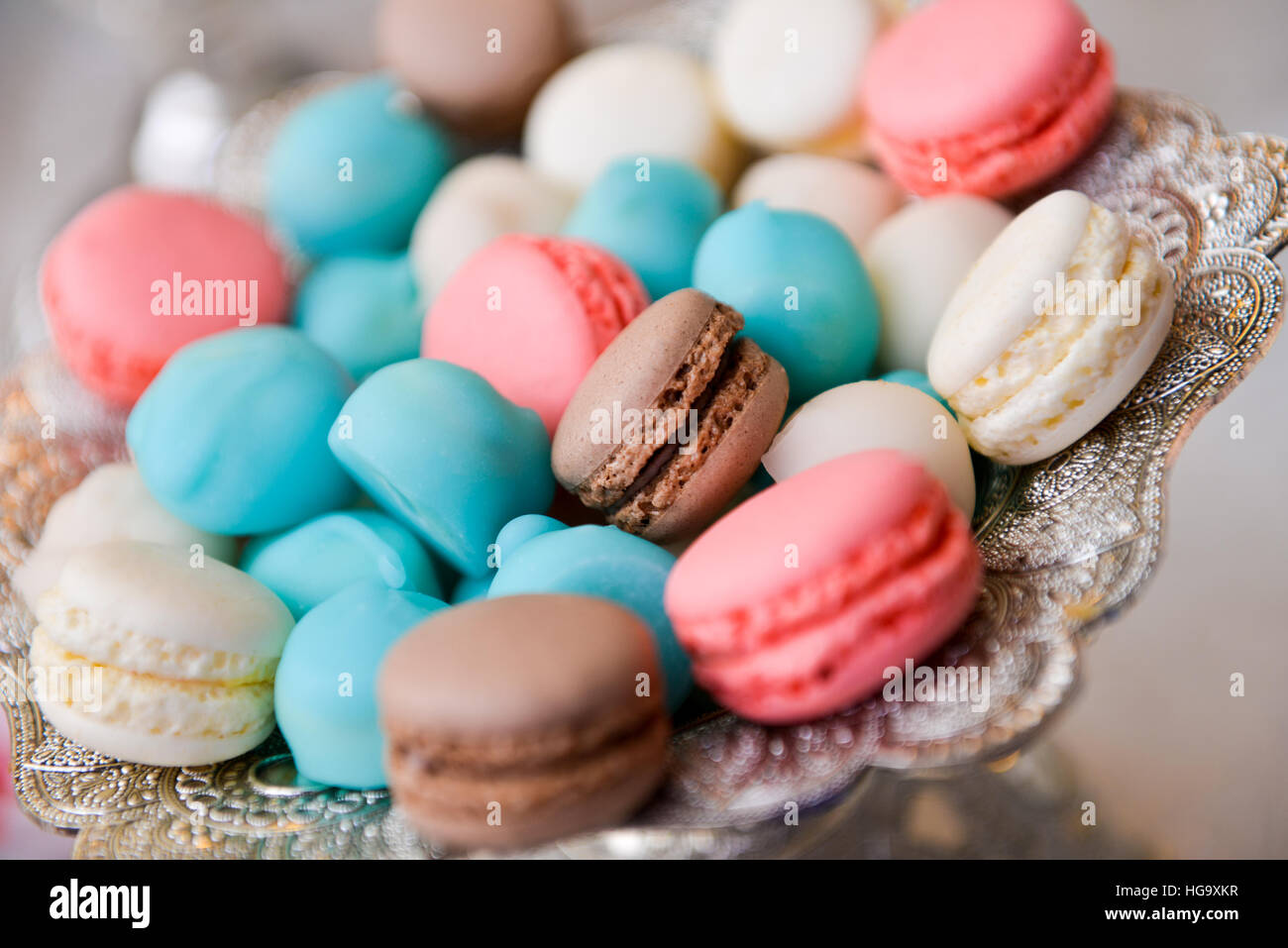 Colorful macarons on a plate on the table Stock Photo