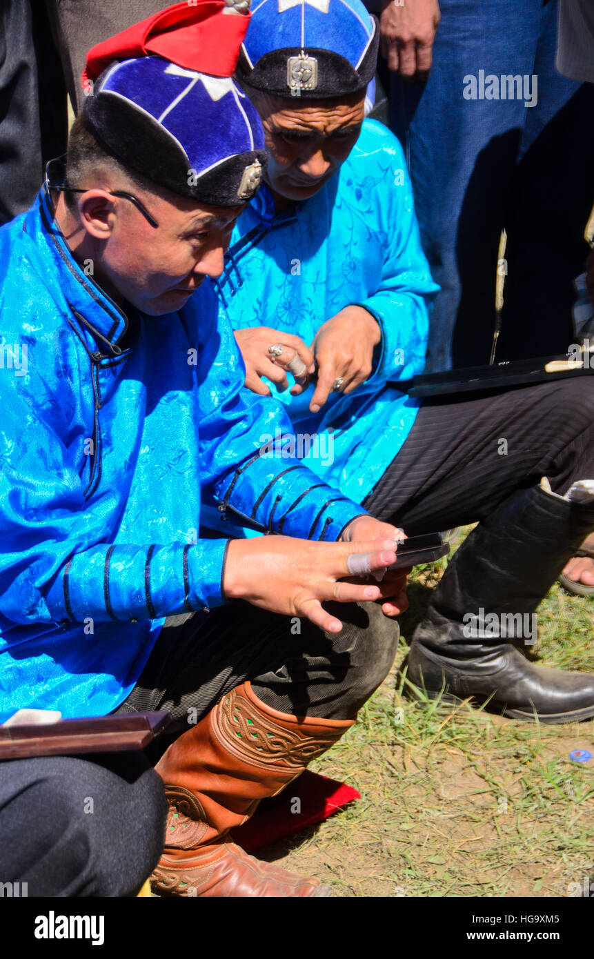 Knuckle-bone players in their traditional outfits. Stock Photo