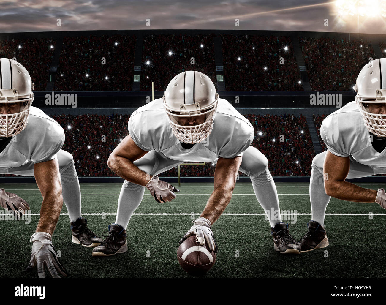 Football Players with a white uniform on the scrimmage line, on a