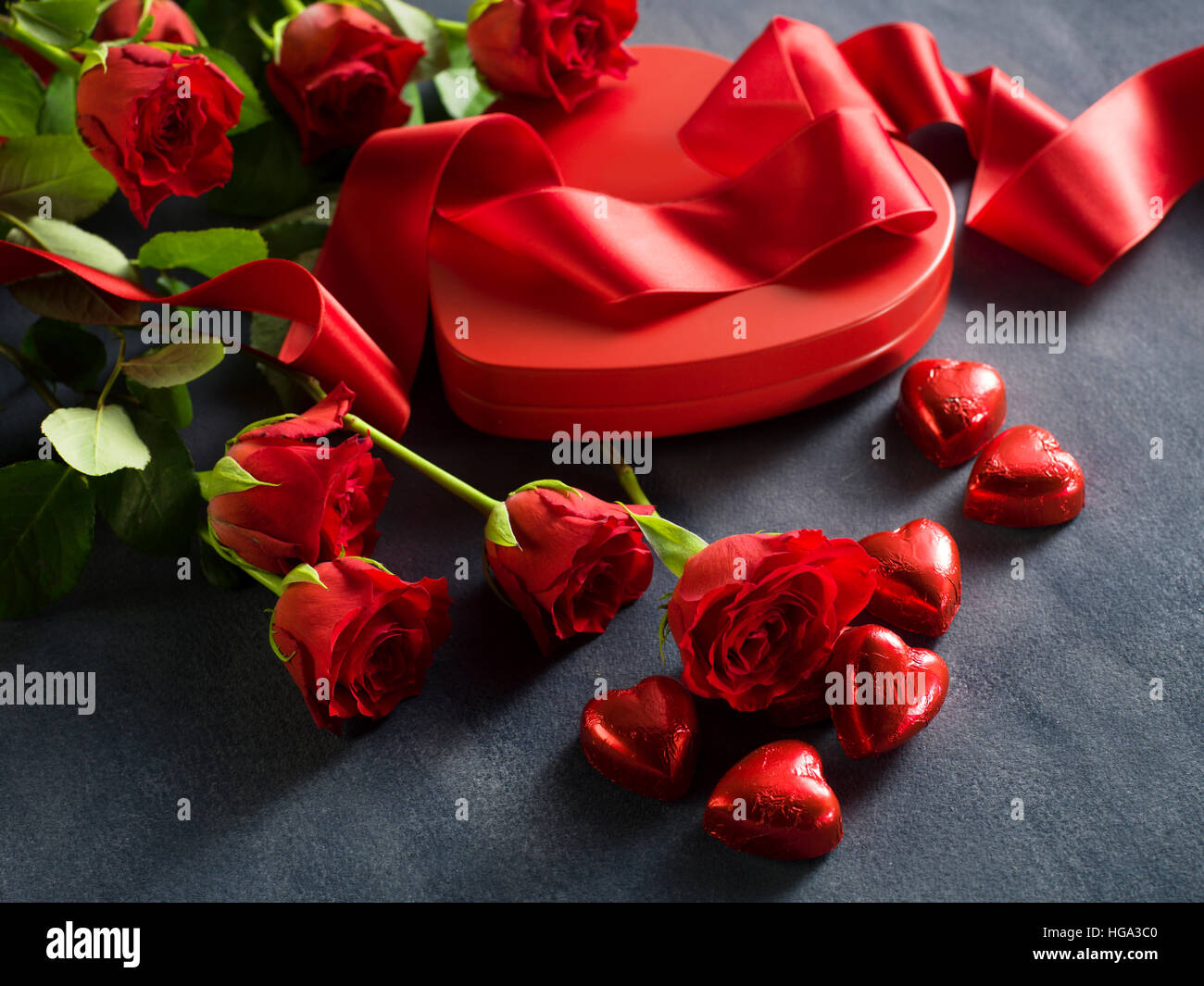 Gift box with red roses and a red ribbon on Valentine's Day Stock Photo ...
