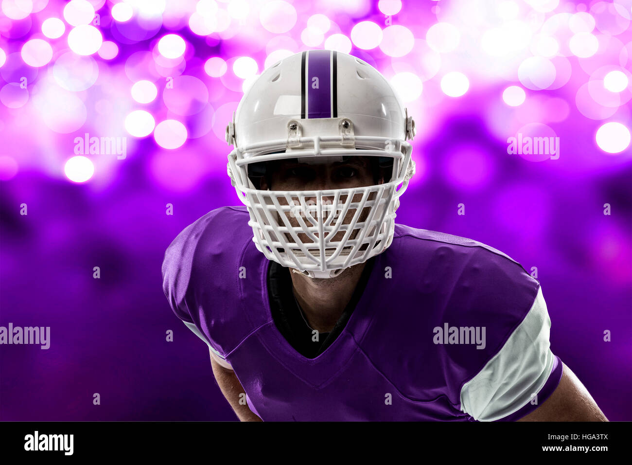 Close up of a Football Player with a purple uniform on a purple lights ...