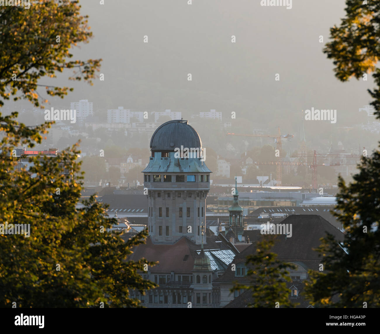 The sun is setting behind Zurich's historic Urania observatory in the city centre. Stock Photo