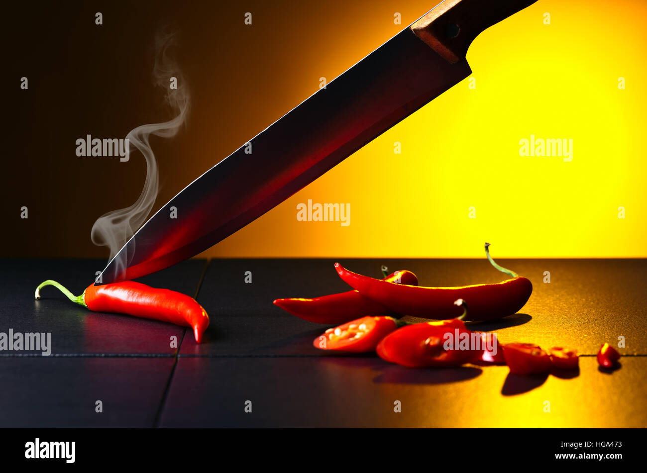 Hot red chilli pepper on black table Stock Photo - Alamy