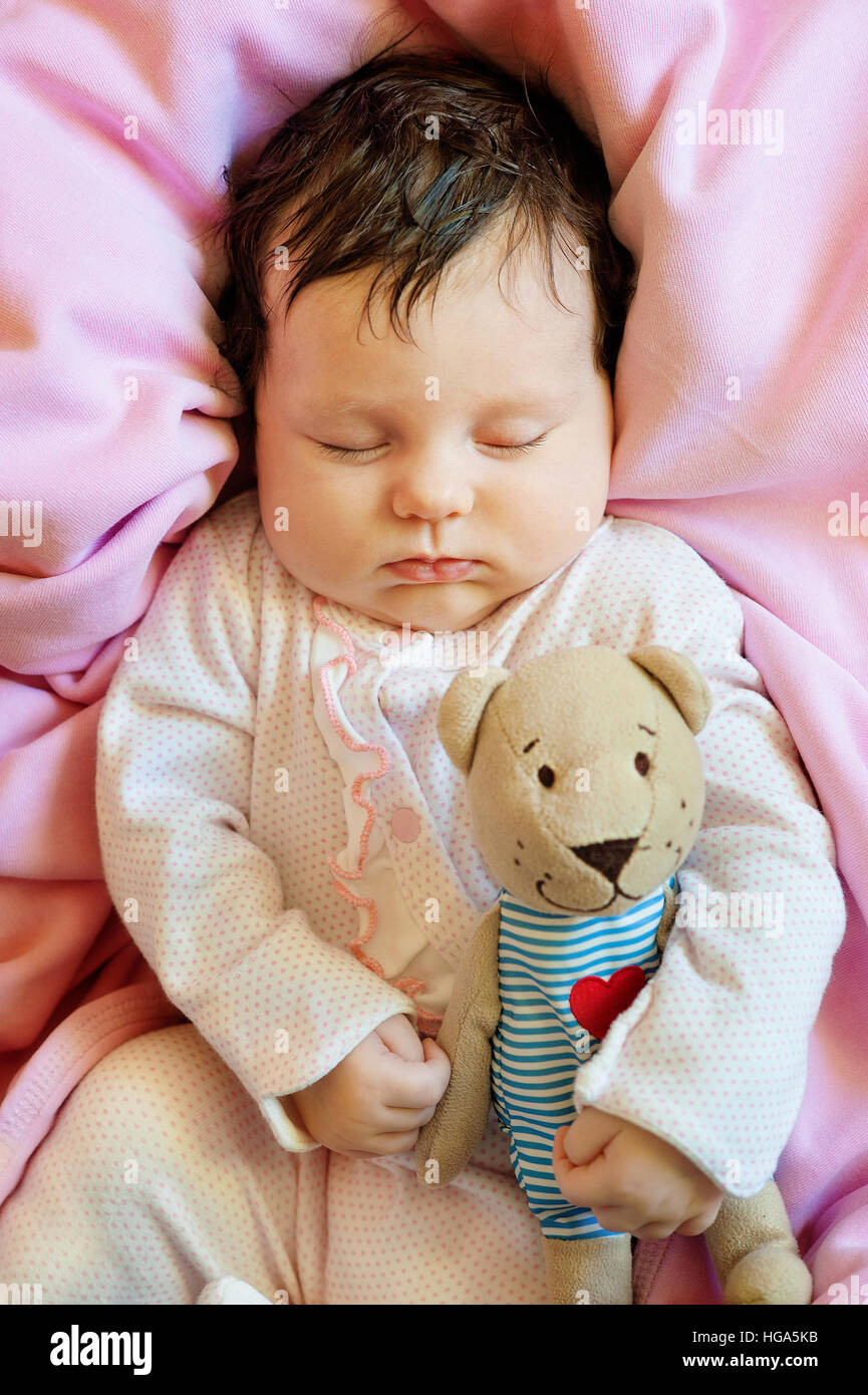 Cute newborn baby sleeps with a toy teddy bear Stock Photo Alamy