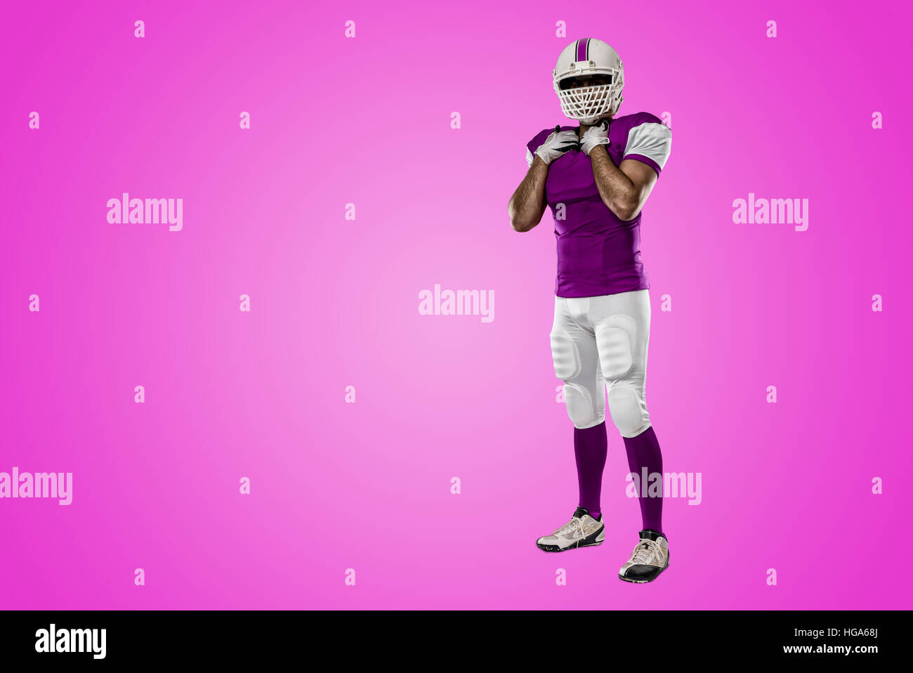 Football Player with a pink uniform on a pink background Stock Photo