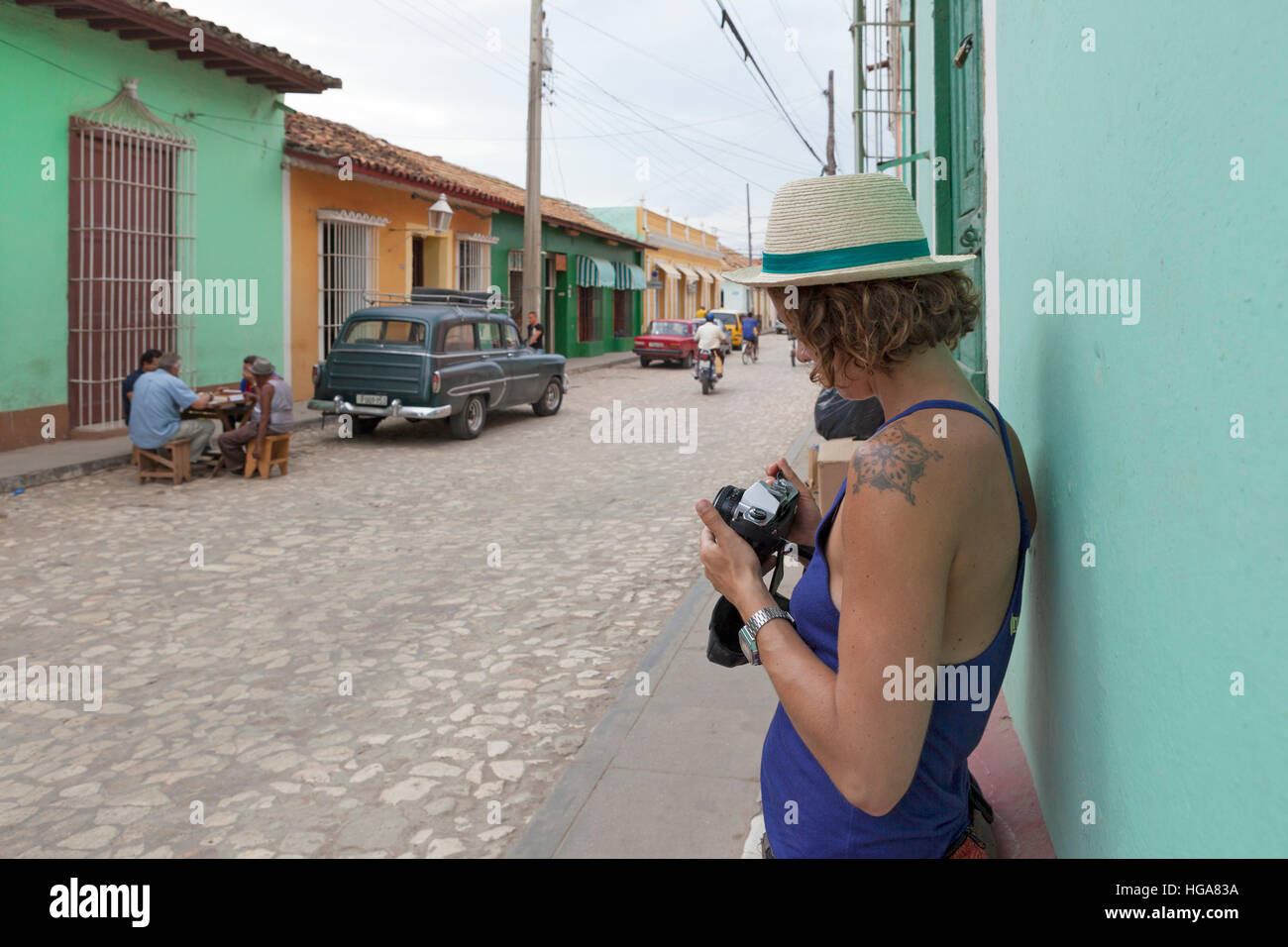 Girl tourist on her 20 30 years old taking photo in Trinidad, Cuba Stock Photo