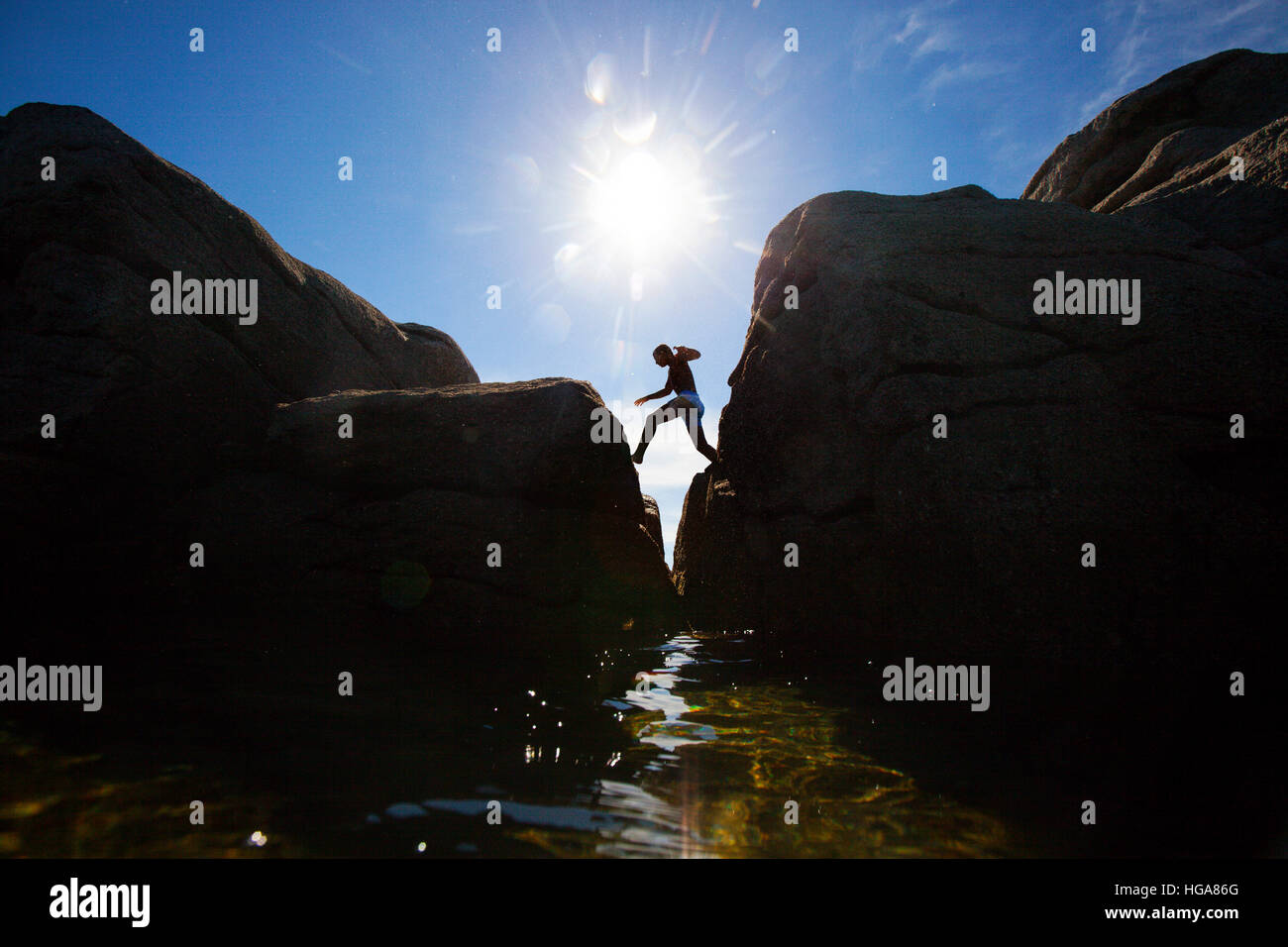 Person Jumping Between Rock In Ile De Groix Stock Photo