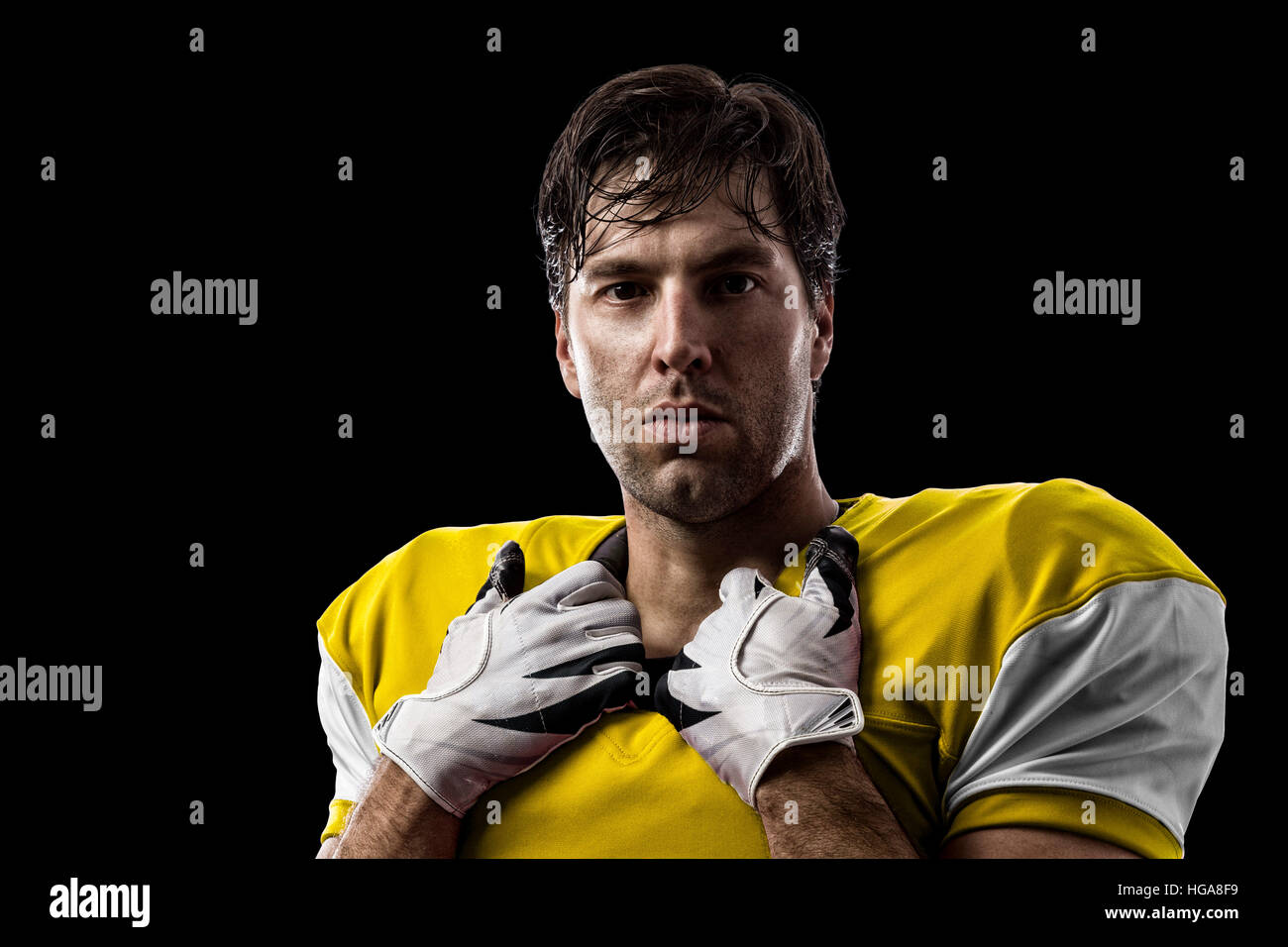 Football Player with a yellow uniform on a black background Stock Photo