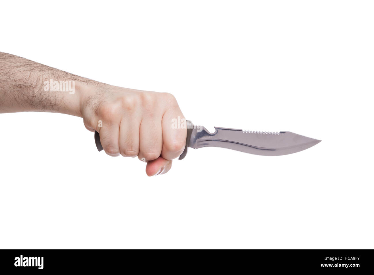 Hand holding a hunting knife in a stabbing gesture isolated on white