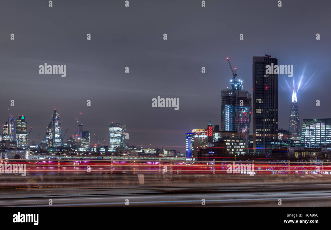 London skyline at night with light streaks and light show as seen from Waterloo bridge Stock Photo