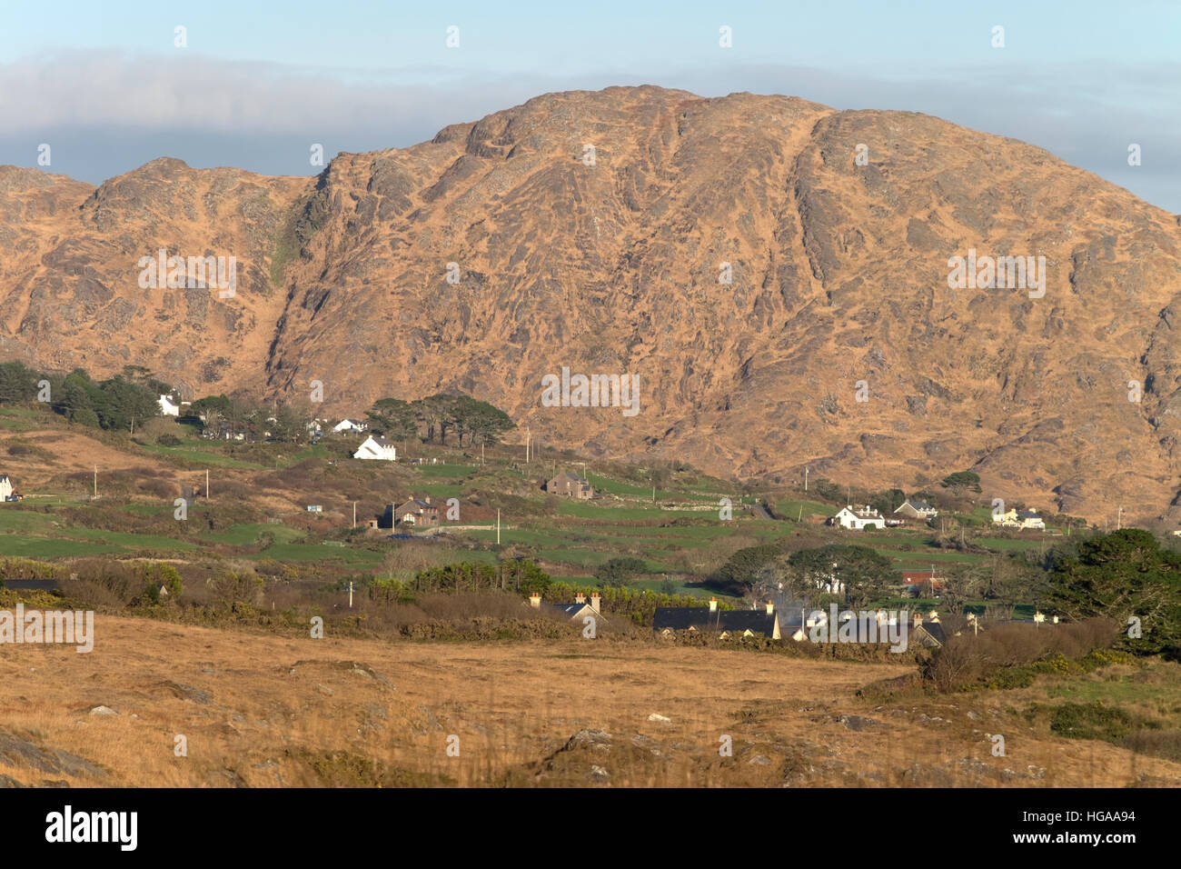 Houses nestle at the foot of a hill on the Sheep's Head Peninsula, Kilcrohane, County Cork