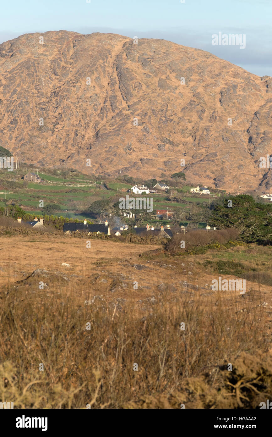 Houses nestle at the foot of a hill on the Sheep's Head Peninsula, Kilcrohane, County Cork