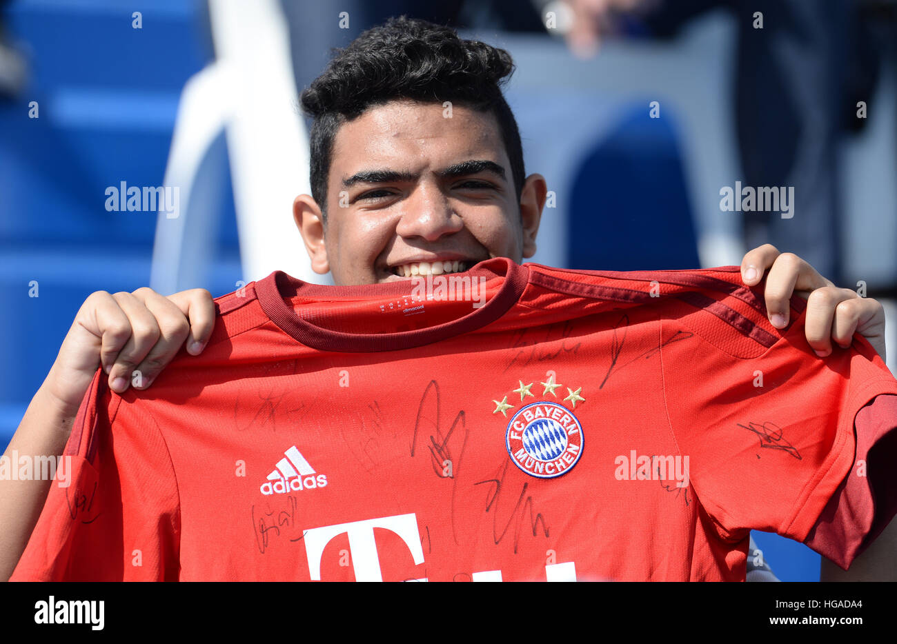 A fan shows a photo and a team jersey of Brazilian football star Ronaldo  Luis Nazario de Lima, commonly known as Ronaldo, to welcome him at the Hong  K Stock Photo 