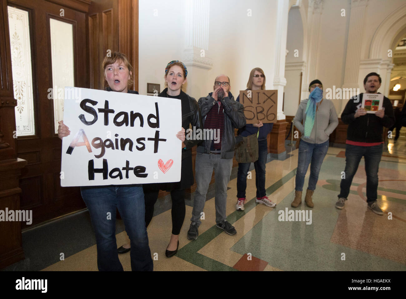 Protesters yell in the hallway as Texas Sen. Lois Kolkhorst, (R-Brenham) and Lt. Gov. Dan Patrick outline the filing of Senate Bill 6 a privacy protection measure known as the 'bathroom bill'. The bill would require transgender Texans to use their birth gender in determining bathroom use Stock Photo