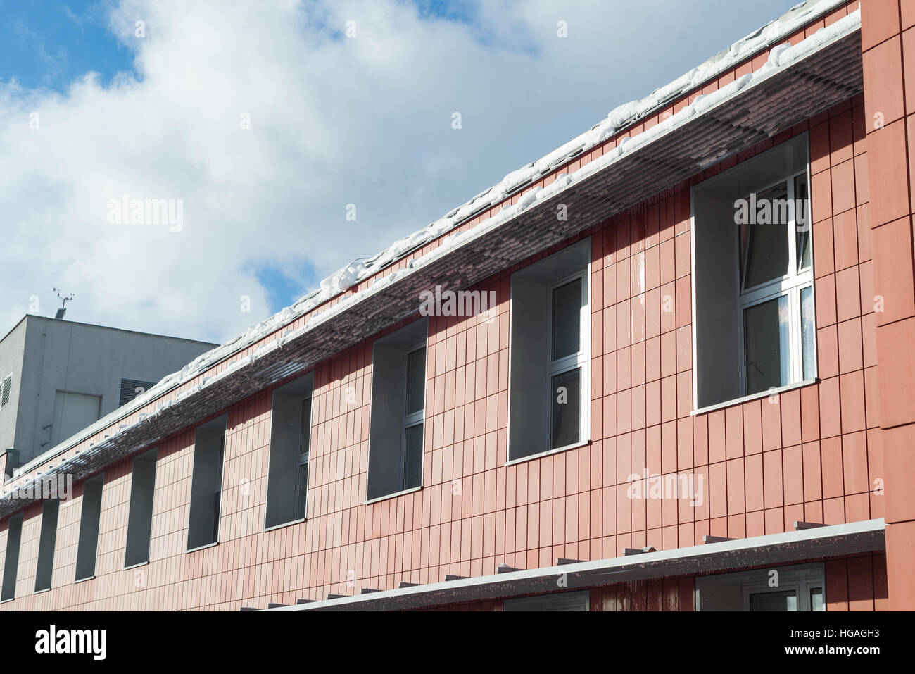 Snow on a roof - risk of falling and sliding down, caution Stock Photo
