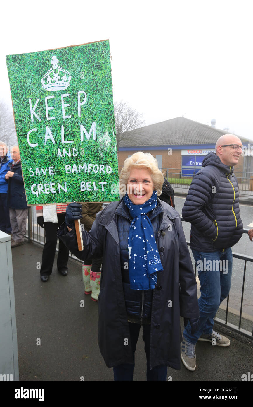 Rochdale, Lancashire, UK. 7th January, 2017. A member of the committee set up to organise against plans for houses to be built on green belt holds up a placard which reads 'Keep calm and save Bamford Green Belt', Bamford, Rochdale, 7th January, 2017  © Barbara Cook/Alamy Live News Stock Photo