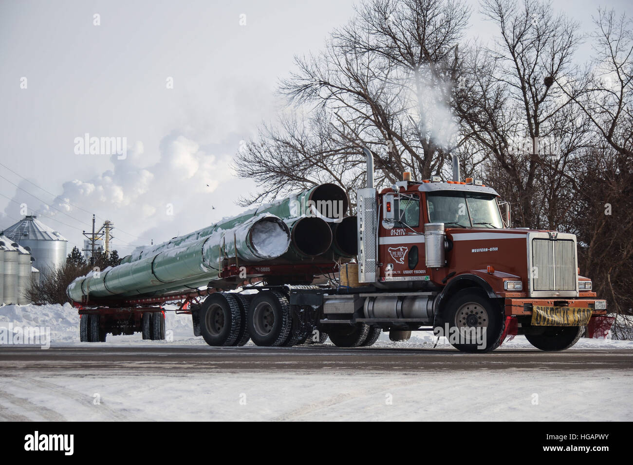 Richardton, North Dakota, USA. 6th Jan, 2017. A truck hauls pipeline used for the Dakota Access Pipeline toward a construction site from a storage facility in Richardton, North Dakota. © Joel Angel Juarez/ZUMA Wire/Alamy Live News Stock Photo