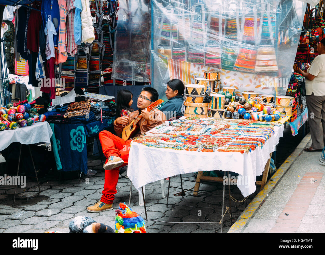 Traditional street market in Otovalo, Ecuador, full of textiles, fruit and vegetables, spices, jewerly and indigenous carvings Stock Photo