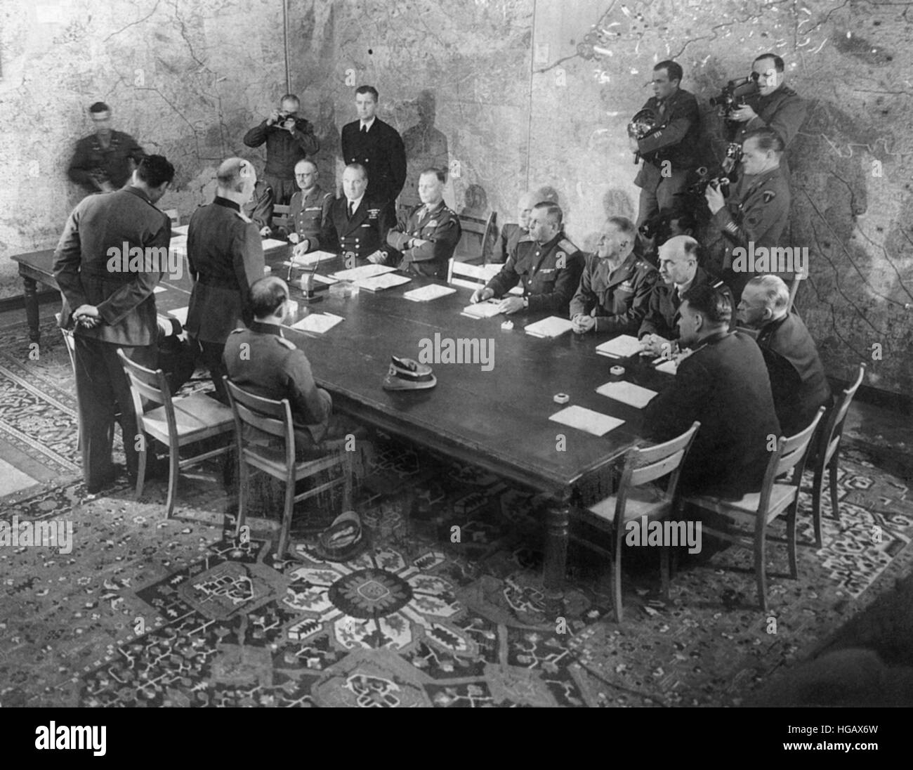 WW2 GERMAN SURRENDER  7 MAY 1945. On behalf of the German High Command General Alfred Jodl prepares to sign the unconditional surrender document at Allied HQ, 12 rue Franklin Roosevelt, Rheims. See Description below. Stock Photo