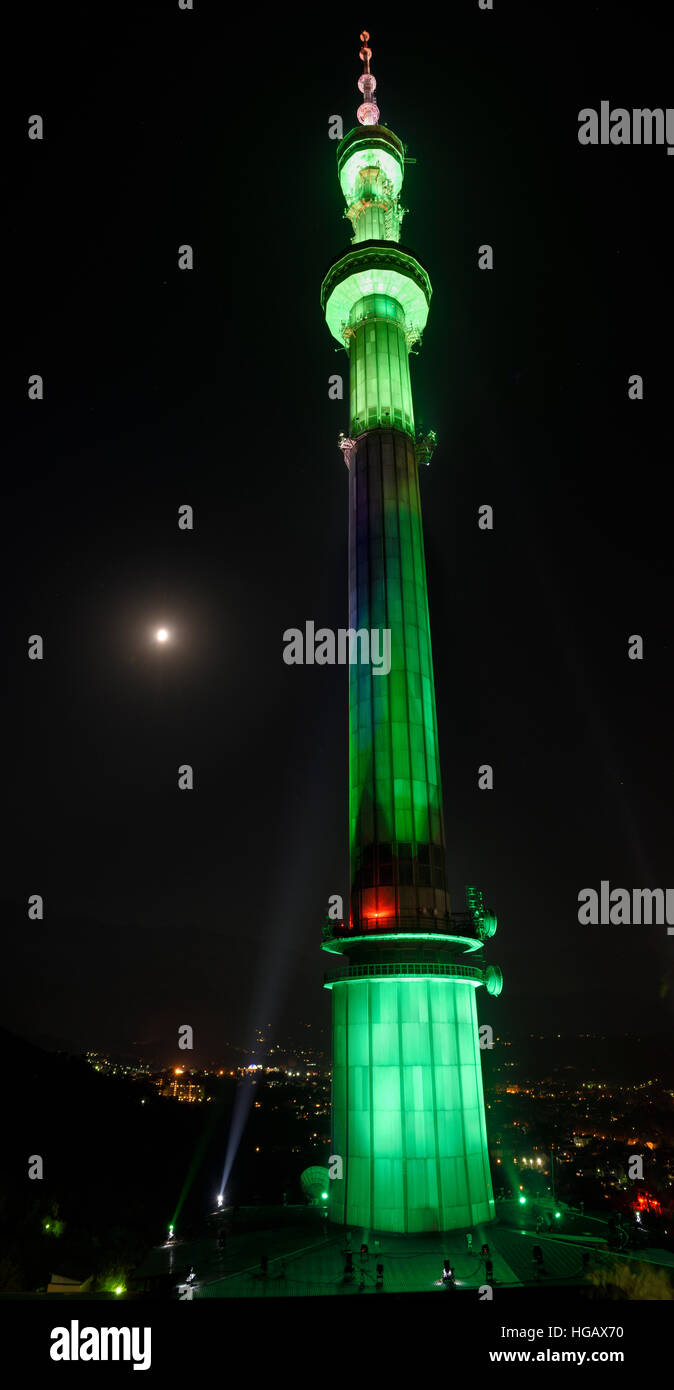 Green lights on Almaty TV tower on Kok Tobe mountain at night with moon Kazakhstan Stock Photo