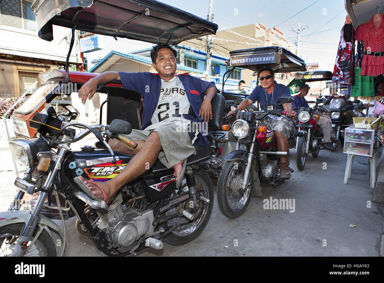 A line of Filipino trike drivers waiting for passengers in Barretto Town, Subic Bay, Luzon Island, Philippines. Stock Photo
