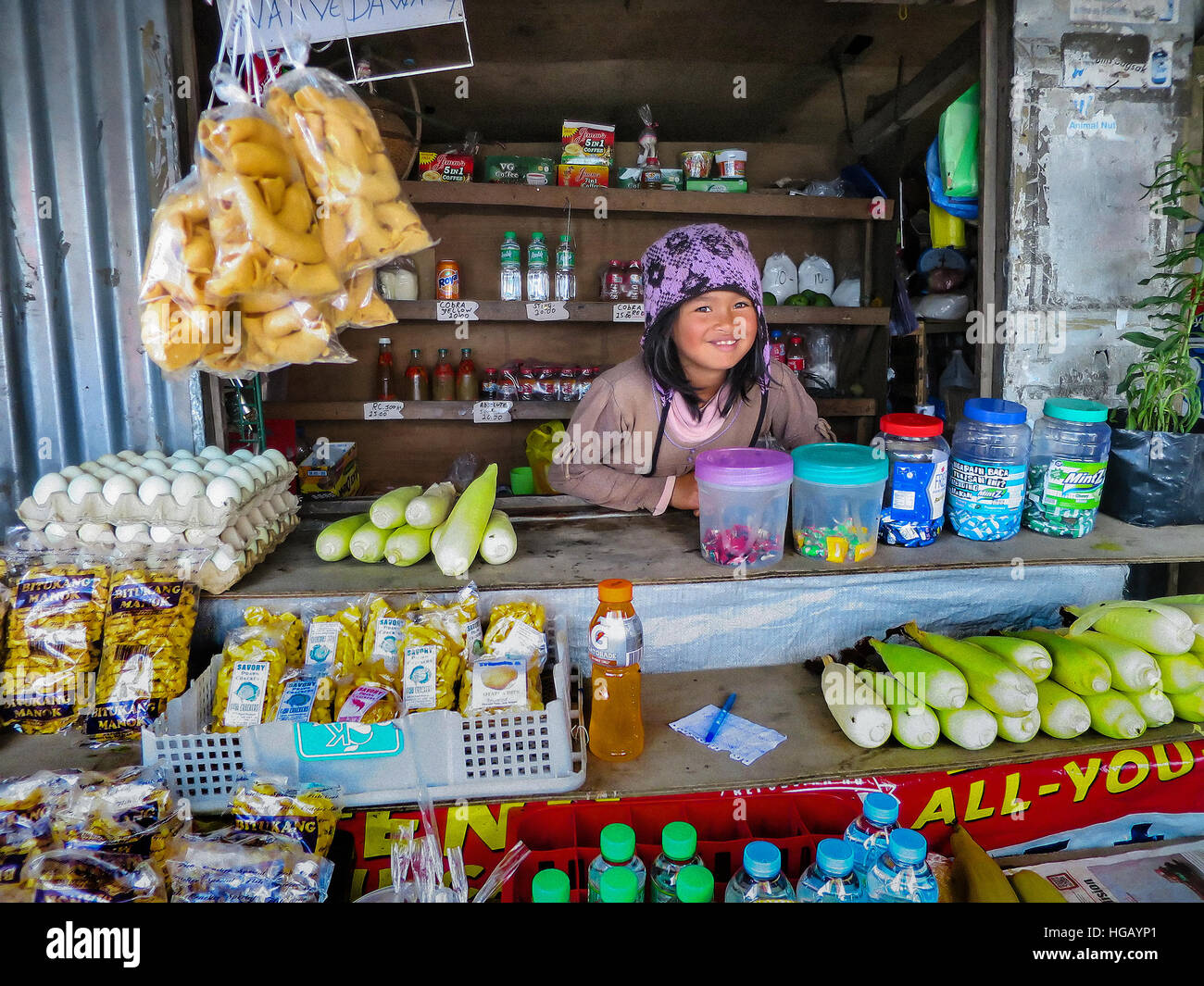 A young Ifugao girl works at a roadside convenience store in the Cordillera Mountains of northern Luzon Island, Philippines. Stock Photo