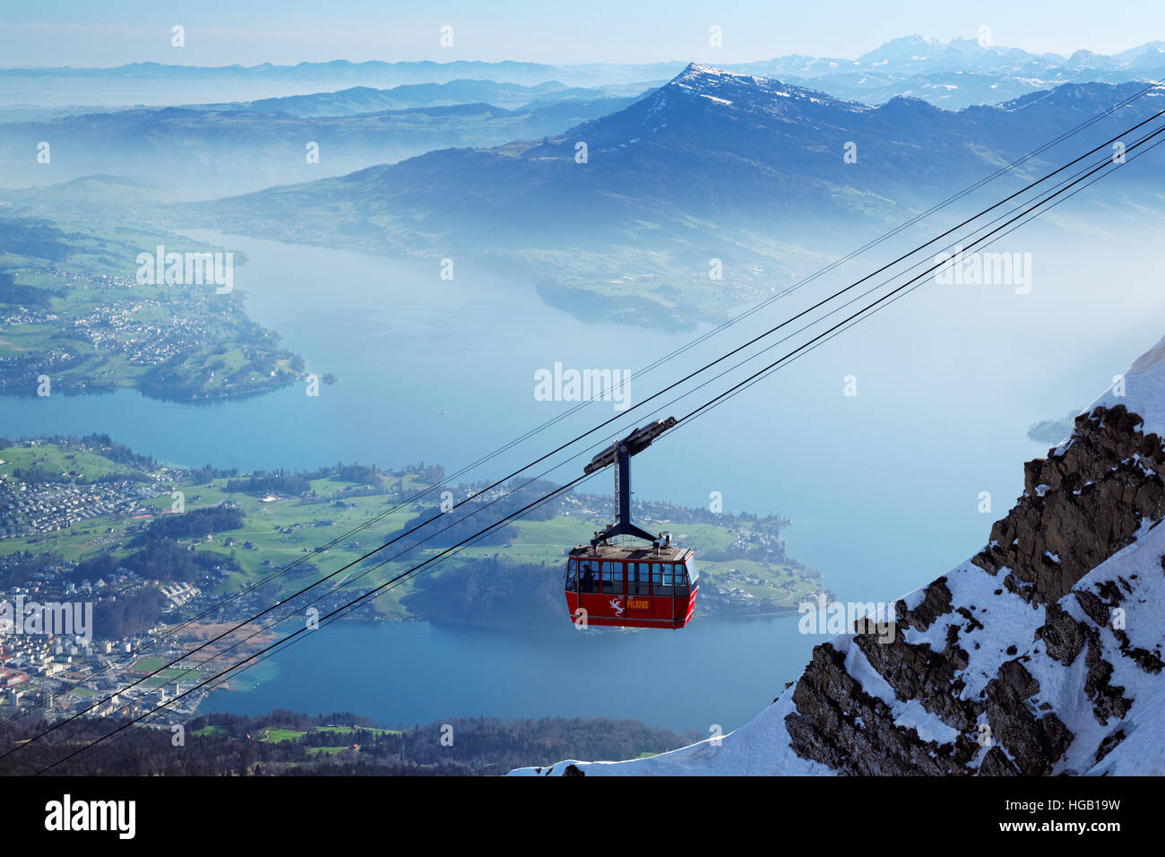 Gondola lift hanging from cables high above Lake Lucerne, near summit of Mount Pilatus, Switzerland Stock Photo